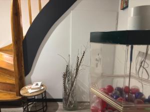 a glass vase filled with red grapes next to a staircase at Hotel Zur Krone in Nordwalde