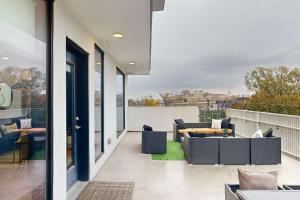 a patio with couches and tables on a balcony at Illume 407 in Nashville