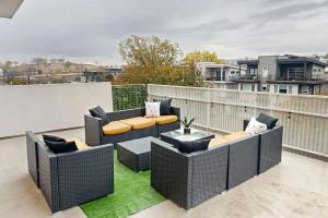 a patio with couches and a table on a balcony at Illume 407 in Nashville +28 photos