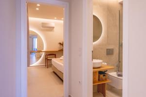 a bathroom with a sink and a toilet in a room at GuVer Luxury Suites in Agia Anna Naxos +54 photos