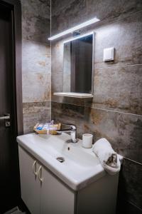 a bathroom with a sink and a mirror at Infinity Apartman in Esztergom +30 photos