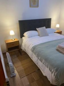 a bedroom with a large bed with two night stands at Casa Ckunna in San Pedro de Atacama