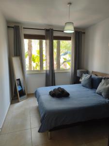 a bedroom with a blue bed with a mirror at Oroklini by the pool in Oroklini +29 photos