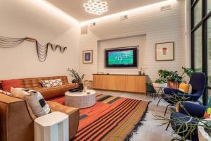 a living room with a couch and a tv at River Walk in San Antonio