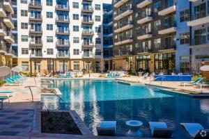 a swimming pool in front of a large apartment building at River Walk in San Antonio