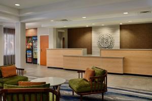 a waiting room with chairs and a table and a counter at Fairfield Inn and Suites by Marriott Saint Augustine I-95 in St. Augustine +45 photos