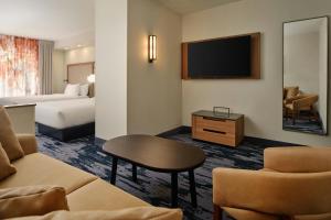 a hotel room with a bed and a flat screen tv at Fairfield Inn and Suites by Marriott Saint Augustine I-95 in St. Augustine