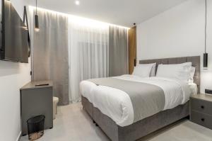 a bedroom with a large bed and a television at Elia village in Kalithies