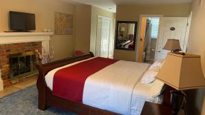 a bedroom with a bed and a fireplace at Bruce Manor in Niagara-on-the-Lake
