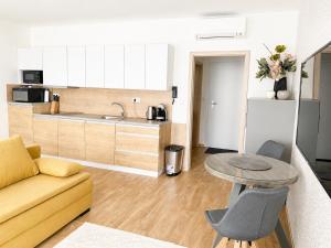 a living room with a couch and a table at Apartmán Mia in Mikulov