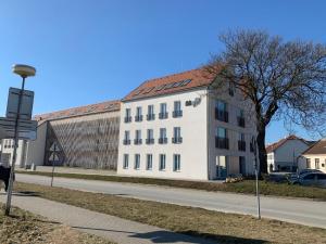 a white building on the side of a street at Apartmán Mia in Mikulov