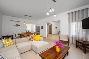 a living room with a couch and a table at Polytimi Summerhouse in Ialysos