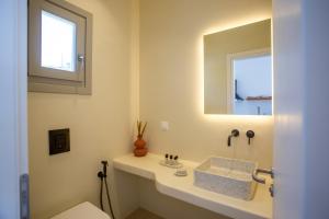a bathroom with a sink and a mirror at Stilvi Mykonos in Ornos +34 photos