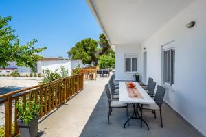 a balcony with a white table and chairs at Polytimi Summerhouse in Ialysos