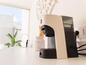 a white and black blow dryer sitting on a counter at Casa Nacci Accoglienza di Lusso in Brindisi