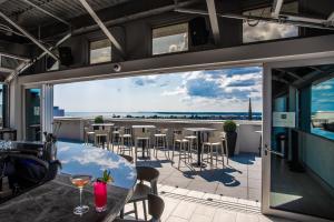 a balcony with a table and chairs and a view of the ocean at Aloft by Marriott Buffalo Downtown in Buffalo