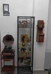 a glass display case filled with lots of items at Hostal Santa Barbara in Santo Domingo