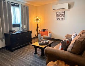 a living room with two couches and a coffee table at Heart & Hops Brewery Suites in Kingsville