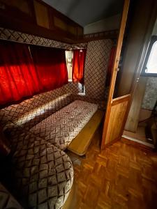 a small room with a bed and a window at Camp pey in Saubion