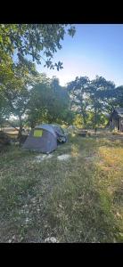 two tents in a field with trees in the background at Camp pey in Saubion