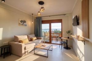 a living room with a couch and a table at seaandolive in Ammouliani