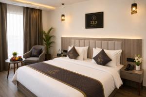 a hotel room with a large bed and a chair at ZED Plaza in New Delhi +17 photos