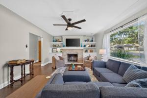 a living room with blue couches and a fireplace at Glenside Getaway in Muskegon