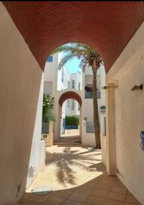 an archway with a palm tree and a building at Dar el Bahri in Beni Khiar