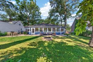 a house with a yard with a fire pit at Glenside Getaway in Muskegon