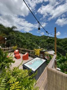 a patio with a hot tub on a deck at Hacienda Tres Casitas in Cabo Rojo