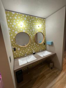 a bathroom with two sinks and two mirrors at Cafe&Stay Stella in Minakami +33 photos