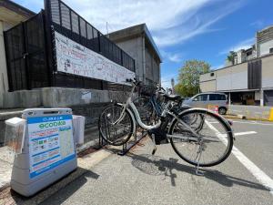 a bike parked next to a sign on a street at Cafe&Stay Stella in Minakami