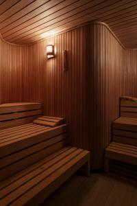 a sauna with two benches and a light on the wall at Nômade Temple Madrid in Madrid +62 photos