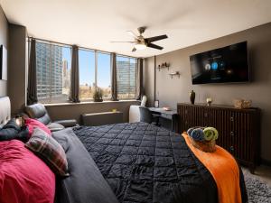 a bedroom with a large bed and a tv at Beautiful 3BR Condo in DTWN Pool Access in Atlanta +33 photos