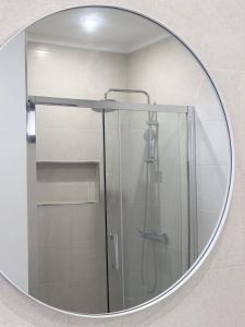 a mirror in a bathroom with a shower at Waves Madeira II in Caniçal