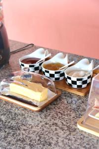 a table with a tray of cheese and bowls of sauce at Hostal Santa Barbara in Santo Domingo +7 photos