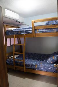 a bunk bed with a ladder in a room at Torogoz Home in San Salvador