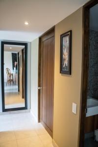a hallway with a door and a picture on the wall at Torogoz Home in San Salvador