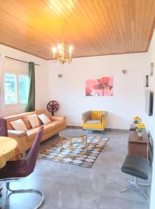 a living room with a couch and a table at Résidence Merveilles G06 in Kribi