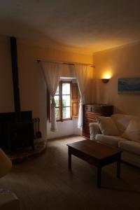 a living room with a couch and a coffee table at Sa Plana Petit Hotel in Estellencs