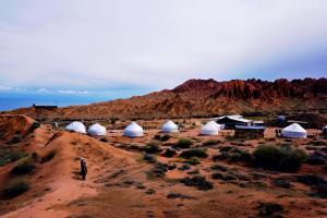 a group of tents on a hill in the desert at Mars Canyon Yurt Camp in Tong