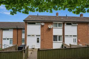 a brick house with white doors and a fence at Hill's View - 6 Sleeps - 10 minute walk to the town in Barnstaple