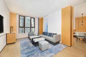 a living room with a couch and a tv at Fairfield by Marriott Ningde Xiapu in Xiapu
