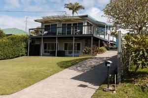 a house with a fence in front of it at The Mullet in Nambucca Heads