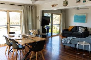 a living room with a table and a couch at The Mullet in Nambucca Heads