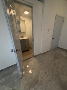 an empty room with two doors and a kitchen at Los Patos Waterfront Private Suites in Los Patos +55 photos