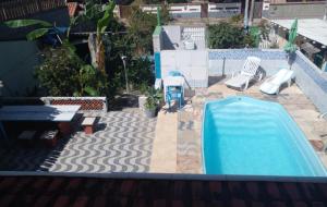 a swimming pool with a slide and a playground at Studio de Temporada de 1 Quarto com Piscina Gruta da Praia 1 in Saquarema +18 photos