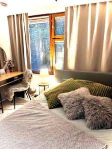 a bedroom with a bed and a desk and a window at Apartment for 5 people in Savonlinna