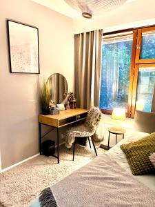 a bedroom with a desk in front of a window at Apartment for 5 people in Savonlinna