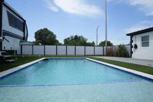 a swimming pool in the backyard of a house at Mango Tree House in Hialeah